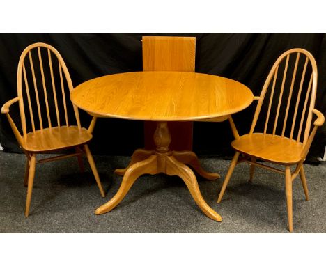 An Ercol light elm extending dining table, pedestal base, 73cm high x 98cm x 111cm oval (extending to 149cm with single addit