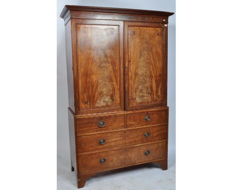 A late 18th Century George III English mahogany country house linen press wardrobe / housekeepers cupboard having a twin flam