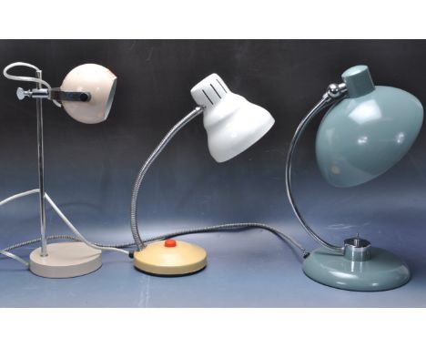 A collection of three retro vintage industrial late 20th century desktop lamps having a white conical lightshade with a fully