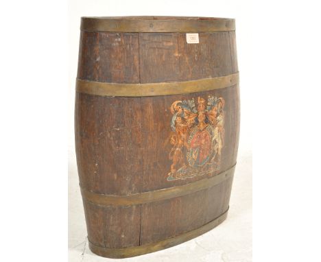 A circa 1900's oak coopered stick stand / barrel of oval form having a royal armorial crest to the front. Measures 52cm.