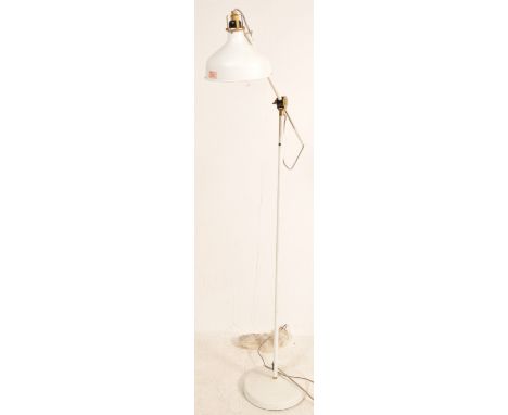 A contemporary industrial reading light / lamp having a conical light shade on a fully adjustable two arm support raised on a