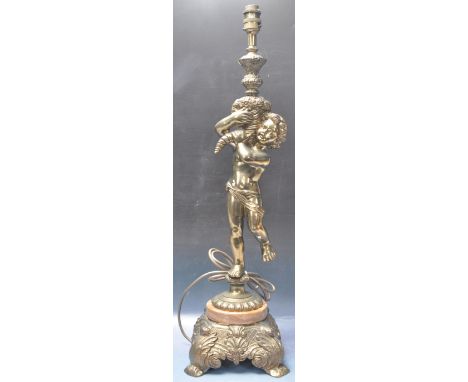 A large late 20th century French brass putti lamp. The lamp having a moulded putti holding a garland of flowers aloft holding