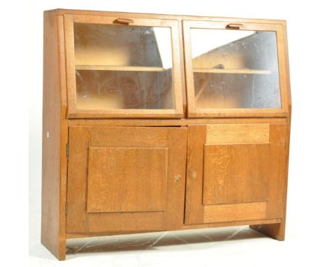 A vintage retro mid 20th century oak display cabinet / bookcase. The cabinet of small proportion with glazed top having inner