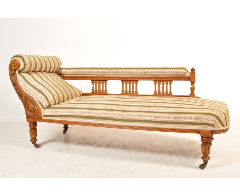 A late 19th century Victorian mahogany chaise longue / day bed. Raised on reeded baluster legs with brown ceramic castors hav