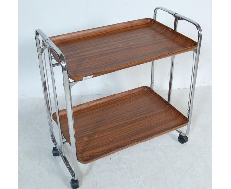 A 1960's folding metamorphic drinks trolley. The design is typical of the 1960's with tubular chrome metal frame, and light w