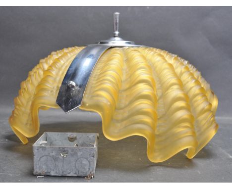 A vintage 1950s mid 20th century Art Deco pressed amber glass light shade in the form of a shell. The light shade has a chrom