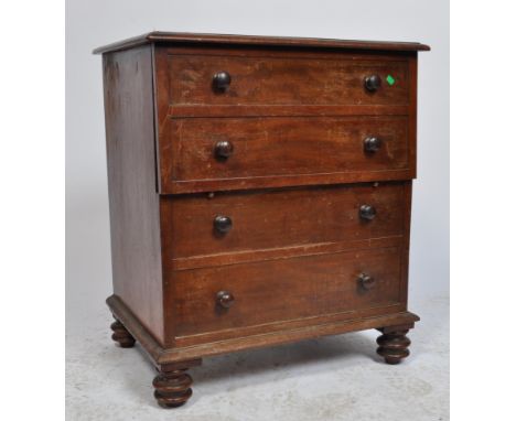 A 19th century Victorian mahogany commode / bachelors chest of drawers. Raised on turned feet with faux chest of drawers fron