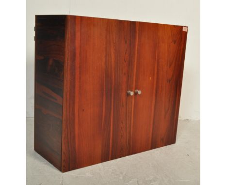 A retro vintage 20th century circa 1970s Danish teak wall mounted unit having double doors opening to reveal a spacious inter