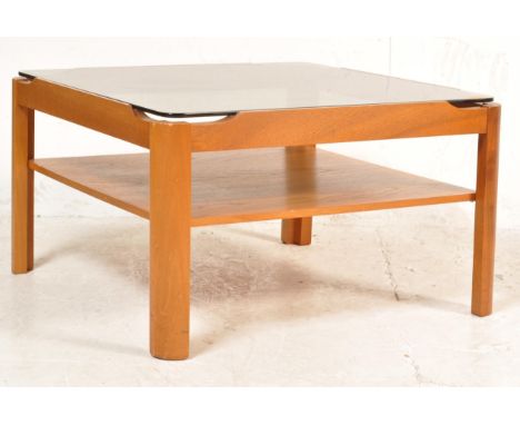 A retro vintage&nbsp; mid 20th century coffee table. The coffee table of a square form with smoked glass top and teak wood fr