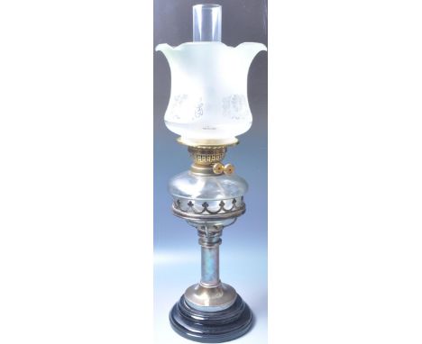 A 19th century Victorian oil lamp having a glass reservoir raised on metal column atop a black marble base.&nbsp;