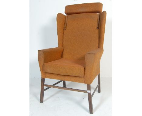 A vintage retro 20th century circa 1970’s Danish inspired wingback armchair / easy chair. The chair of a classical design wit