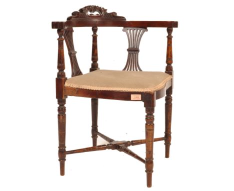 A 19th century late Victorian mahogany corner chair having a shaped backrest with pieced harp backrest raised on turned legs 