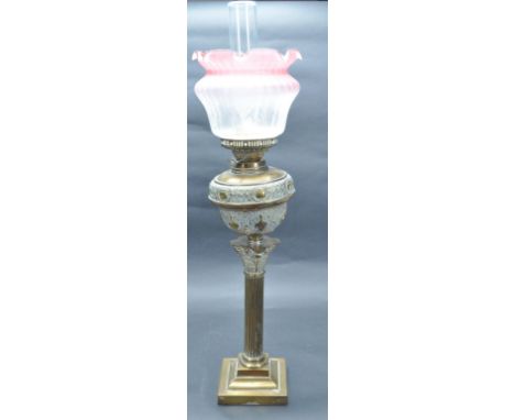 A Victorian 19th century brass oil lamp of Doric column form upon a stepped base, with reeded body and the reservoir having r