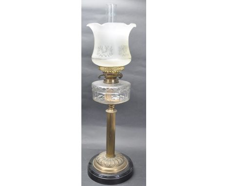 A 19th century Victorian oil lamp having a frosted frilled shade with acid etched decoration, over a clear moulded glass rese