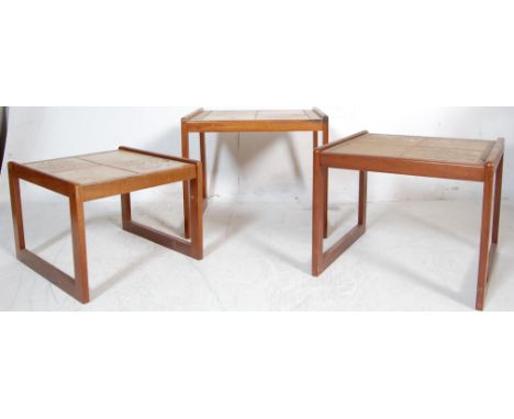 A retro vintage 20th century circa 1970s tile top nest of three graduating tables having foliate decoration to the top raised