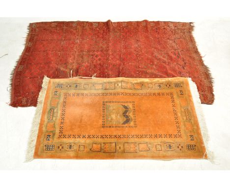 A vintage 20th century Persian Islamic rug having polychrome geometric decoration throughout with tassels to each end along w