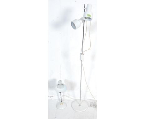 A retro vintage 1970s industrial twin head spotlight / standard lamp in white having fully adjustable spotlight raised on a c