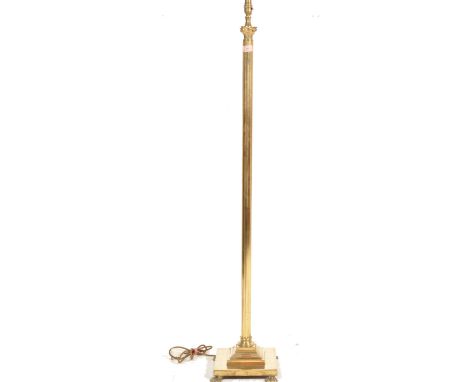 A 1970s vintage neo classical Corinthian column brass standard floor lamp having a stepped base upon lion paw feet.&nbsp;Meas