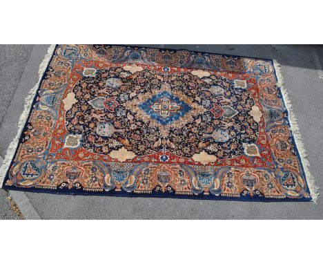 A large 20th century hand woven Persian Islamic Kashmar carpet rug being fine decorated with a large light blue floral medall