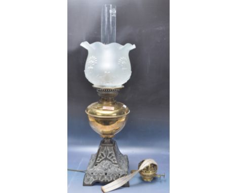 A 19th century Victorian brass oil lamp having a pierced base with floral decoration, brass reservoir and scalloped edge shad