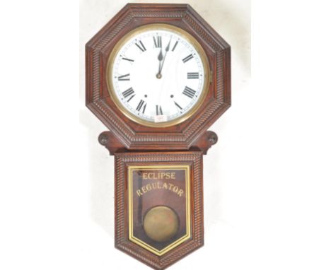 A late 19th Century American Stained Walnut Wall Clock, Newhaven “Eclipse Regulator” having a moulded octagonal surround to a