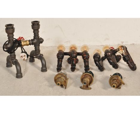 A group of contemporary industrial factory style converted lamps and light fixtures constructed from metal piping. Measures 3