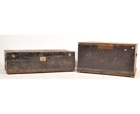 A pair of 19th century Victorian chests comprising of a black pine trunk having a purple top with carry handles to each side 