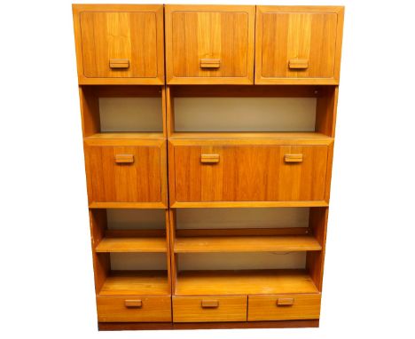 ALFRED COX TEAK WALL UNIT
with a pair of double cupboard doors above an illuminated open shelf with a fall flap below opening