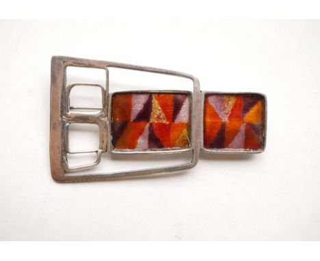 NORMAN GRANT SCOTTISH SILVER BROOCH
of pierced shaped design with panels of enamel decoration in warm orange and purple tones