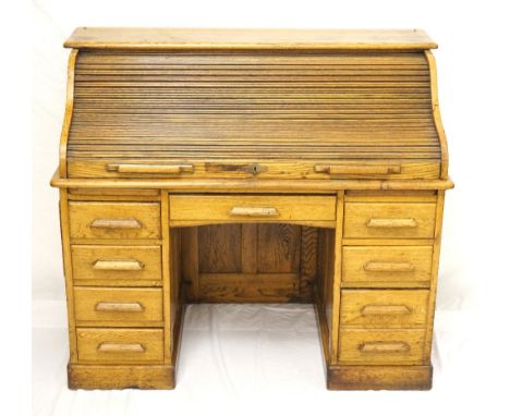 OAK ROLL-TOP DESK
early 20th century, the roll-top opening to reveal pigeon holes and drawers, above a central single drawer 