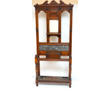 EDWARDIAN OAK HALL STAND
with a shaped carved top rail above a central carved panel with a fan motif and a bevelled mirror be