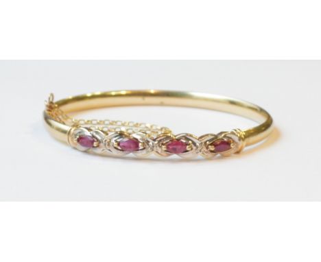 RUBY AND DIAMOND SET BANGLE
in unmarked gold, with safety chain