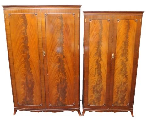 TWO MAHOGANY WARDROBES
with a trade label for 'D. MacDonald & Bros. Ltd., Glasgow', with moulded cornices above figured panel