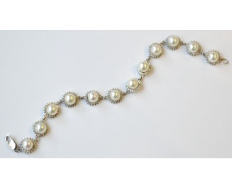 PEARL AND DIAMOND BRACELET
each of the twelve pearls in diamond surrounds totalling approximately 1.7cts, in nine carat white