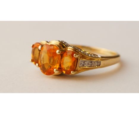 CITRINE AND DIAMOND DRESS RING
the three graduated citrines flanked by diamond set setting and shoulders, on nine carat gold 