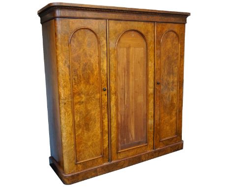 LARGE VICTORIAN MAHOGANY FRAMED TRIPLE-DOOR WARDROBE
with burr walnut veneer facings, shaped and moulded cornice, single and 