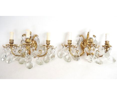 SELECTION OF GILT METAL WALL LIGHTS
comprising four sets, each with three scroll arms with cut glass pendants, two similar tw