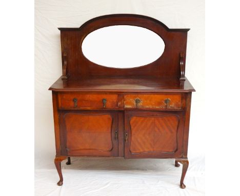 1920's MAHOGANY MIRROR-BACK SIDEBOARD
the shaped back with oval mirror, above twin drawer and cupboard base, raised on cabrio