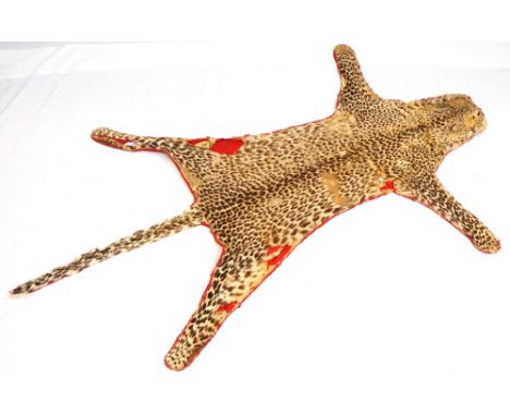 VINTAGE LEOPARD SKIN
with red fabric lining, 179cm long
Note: in its early history the skin is believed to have been used by 