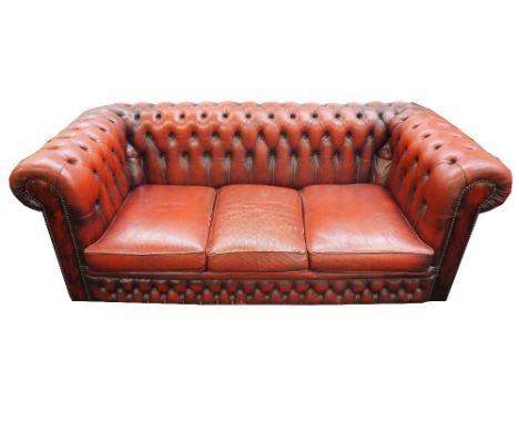 CHESTERFIELD THREE SEAT SOFA
in red leather with button back and scroll arms, 190cm wide 