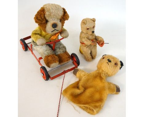 CHILTERN HYGIENIC TOYS PULL ALONG PLUSH BEAR 
in a red metal cart, together with a Sooty plush glove puppet and a clockwork d