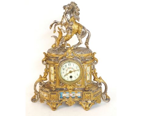 19th CENTURY FRENCH GILT METAL MANTLE CLOCK
with a shaped case surmounted by a rearing horse with attendant, above a circular