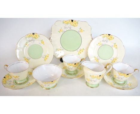 1930's ROSLYN CHINA TEA SET
with handpainted floral decoration, comprising eleven cups, twelve saucers, twelve side plates, c