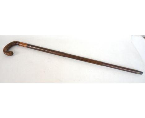 GENTLEMAN'S COMBINATION WALKING STICK AND UMBRELLA
with a simulated rosewood three section tapering body revealing a black um