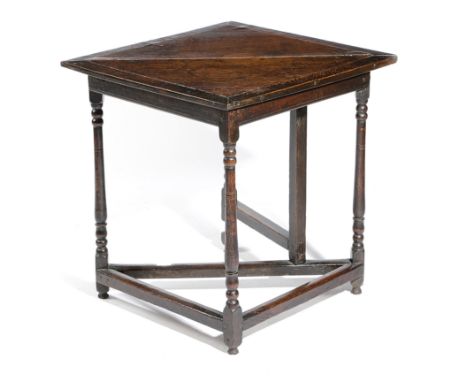 AN OAK CORNER TABLE EARLY 18TH CENTURY the single drop-leaf top on  gate support, with slender baluster turned legs united by