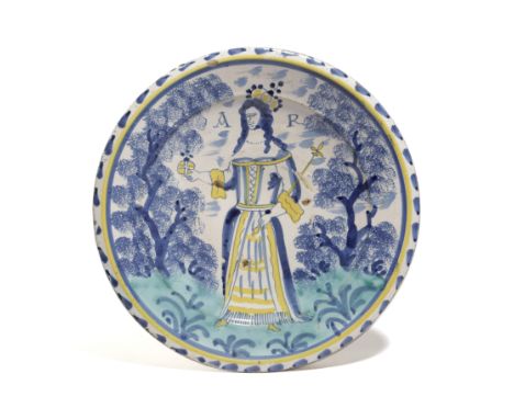 A LONDON DELFTWARE POTTERY QUEEN ANNE CHARGER ATTRIBUTED TO NORFOLK HOUSE, C.1702-14 painted in blue, green and yellow with a