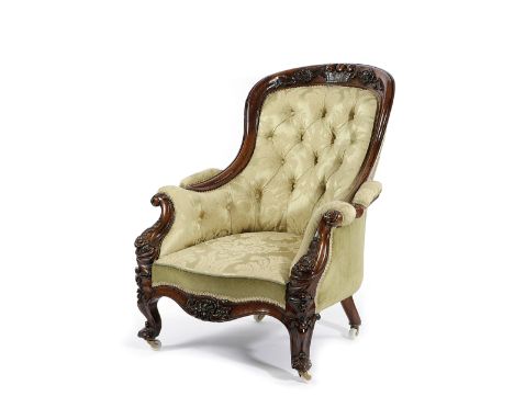 TWO SIMILAR VICTORIAN WALNUT ARMCHAIRS C.1860 each button upholstered with damask fabric, the moulded frame carved with a bas