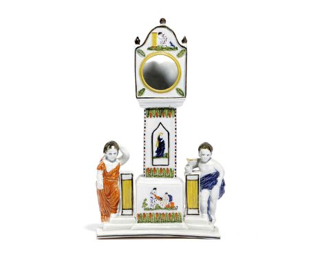 A PRATT WARE POTTERY WATCH STAND NORTH COUNTRY, C.1800 modelled as a longcase clock flanked by a boy and a girl, the case mou