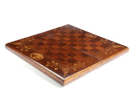 AN IRISH YEW AND MARQUETRY FOLDING GAMES BOARD KILLARNEY, C.1860 inlaid with leaves and oval panels of Ross Castle, the inter