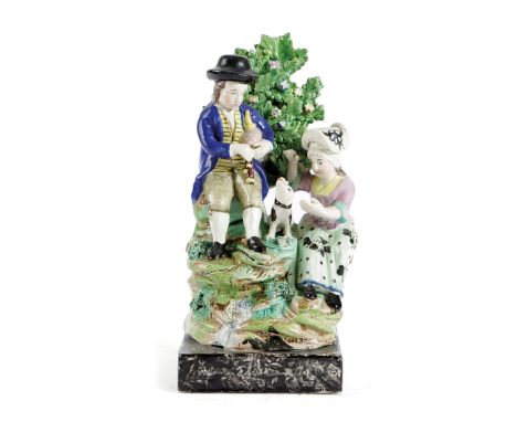 A STAFFORDSHIRE PEARLWARE POTTERY GROUP EARLY 19TH CENTURY depicting rural pastimes, with a man playing bagpipes, accompanied